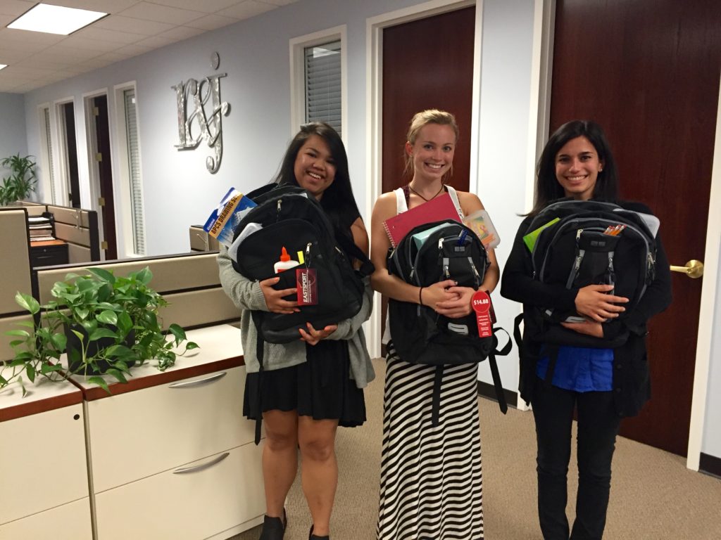 Maria, Heather, and Julia participating in Operation Backpack